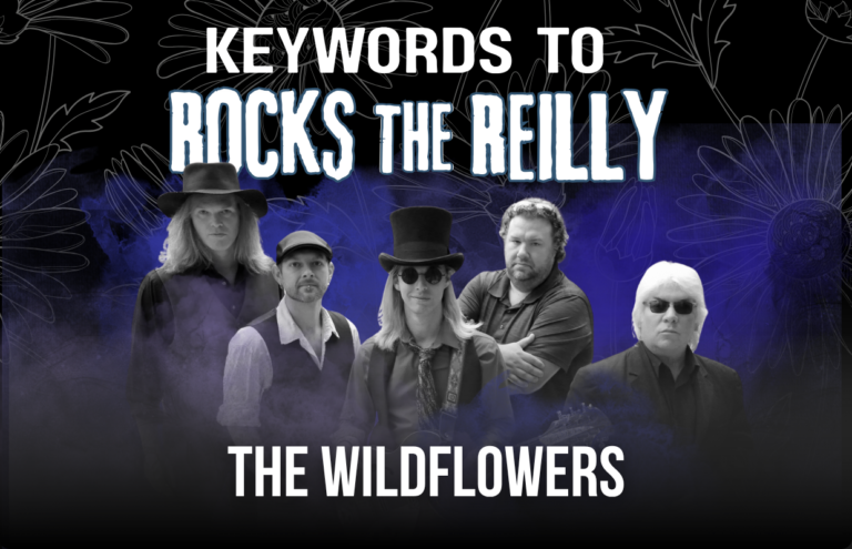 Promotional poster for The Wildflowers band, showing five members with a blue-purple gradient background and bold white text reading 'KEYWORDS TO ROCK THE REILLY' and 'THE WILDFLOWERS' at the bottom.